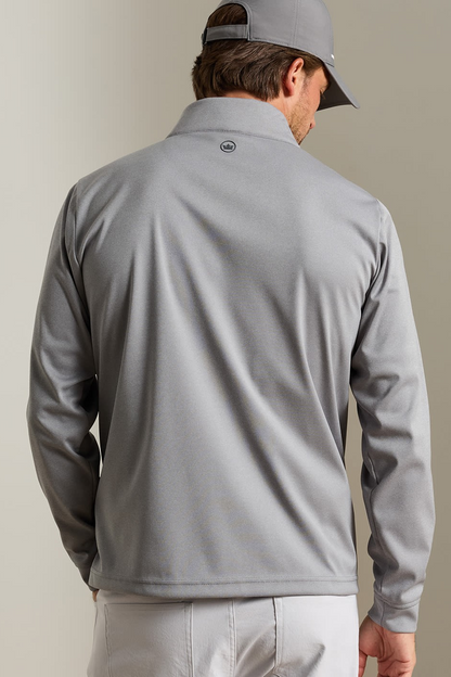 A man shown from the back wearing a light gray long-sleeve quarter-zip performance pullover and a matching gray cap, set against a plain beige studio background.
