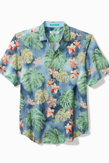 Tropical patterned shirt with leaves and flowers on a white background