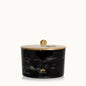 Black marbled candle jar with gold lid on a white background, featuring the Thymes logo.