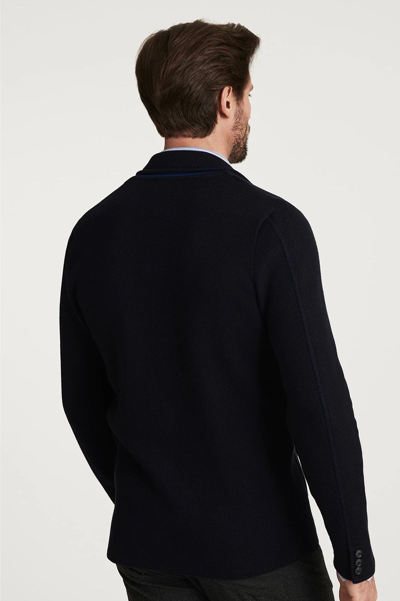 Man wearing a black jacket on a white background