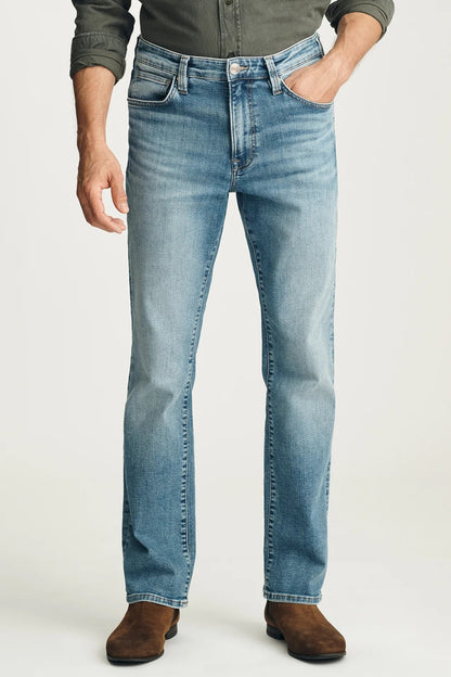 Person wearing blue jeans on a white background