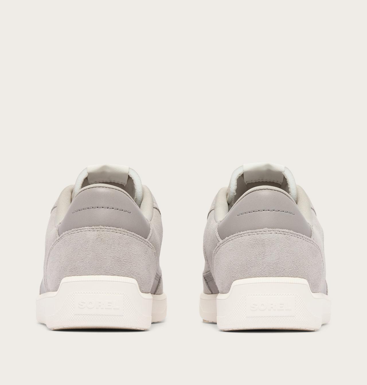 A pair of light gray suede sneakers shown from the back, featuring white soles with the brand name 'SOREN' debossed on the heel.